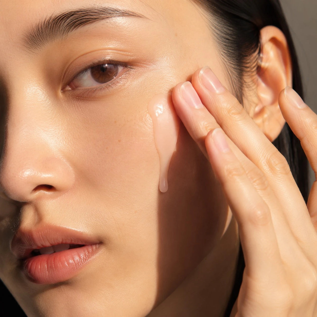 Step 02: a drop of Repair Serum pressed into the cheek